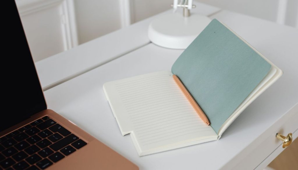 Candidat qui relit sa lettre de motivation sur un ordinateur portable posé sur un bureau